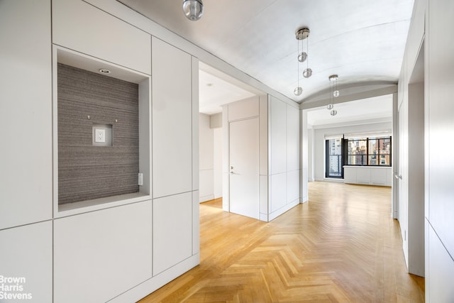 hall featuring vaulted ceiling