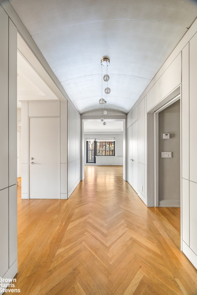 hall featuring vaulted ceiling