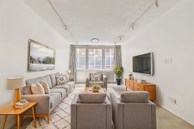 living room featuring track lighting and baseboards