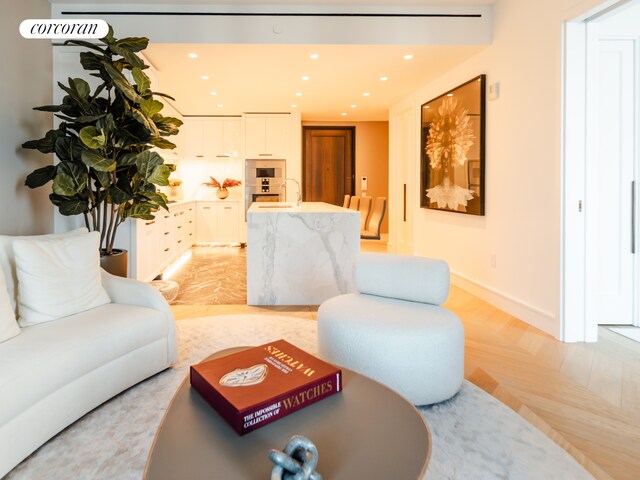 living area featuring recessed lighting and baseboards