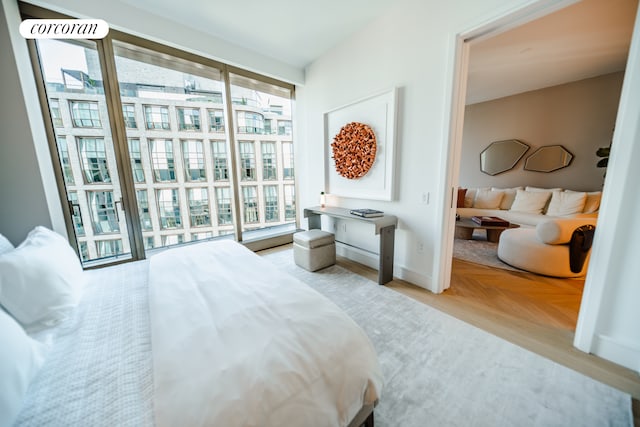bedroom with baseboards and multiple windows