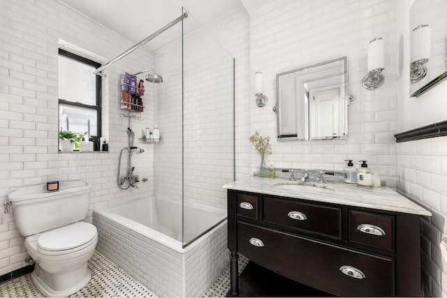 205 E 10th St Unit 2B, New York City, NY 10003 - bathroom with tiled shower / bath combo, toilet, vanity, and tile walls