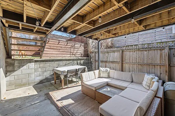 view of patio featuring a fenced backyard, outdoor dining area, and an outdoor living space