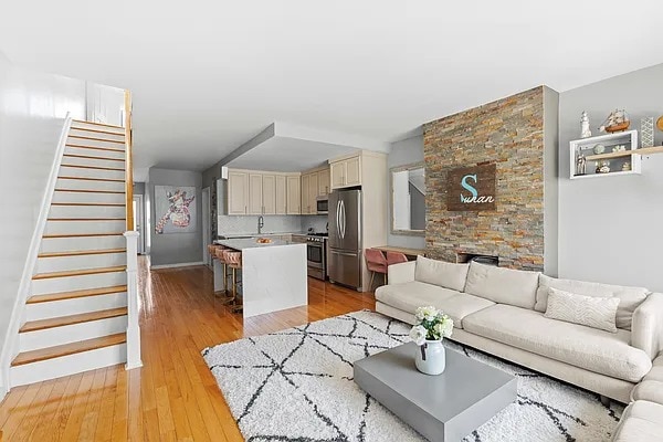 living room with light wood-style flooring and stairway