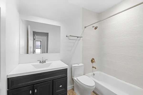 full bathroom with vanity, shower / bathtub combination, and toilet