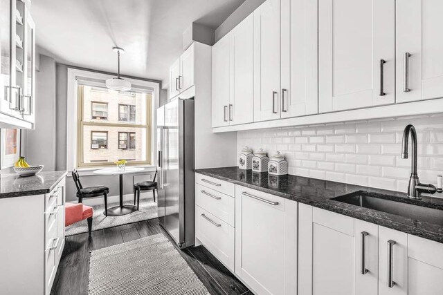 390 Riverside Dr Unit 6D, New York City, NY 10025 - kitchen featuring a sink, high end refrigerator, dark wood-style floors, white cabinets, and plenty of natural light