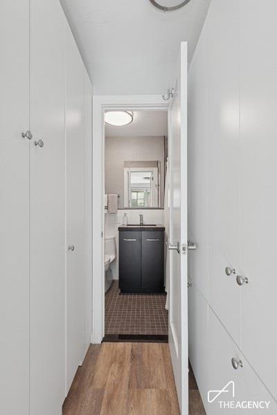 bathroom with wood finished floors, toilet, and vanity