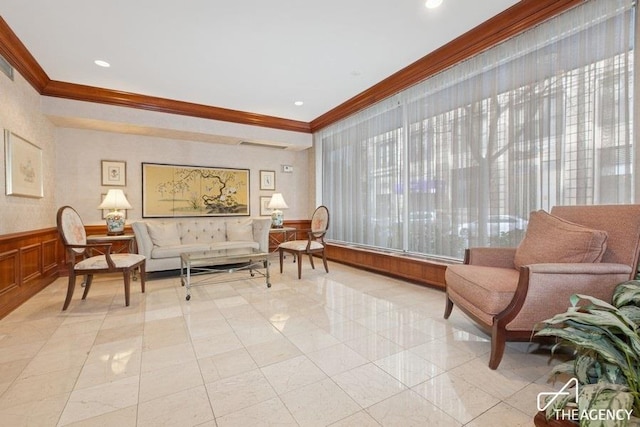 building lobby with crown molding and wainscoting
