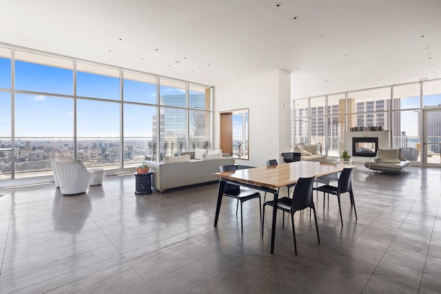 75 Wall St Unit 28-Q, New York City, NY 10005 - dining space with a wall of windows, a high end fireplace, healthy amount of natural light, and a view of city