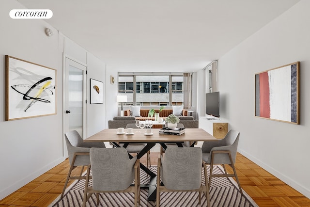 200 E 58th St Unit 10C, New York City, NY 10022 - dining space featuring baseboards