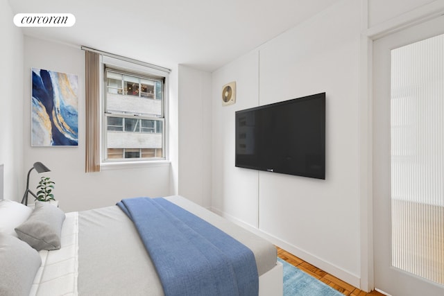 200 E 58th St Unit 10C, New York City, NY 10022 - bedroom with wood finished floors and baseboards