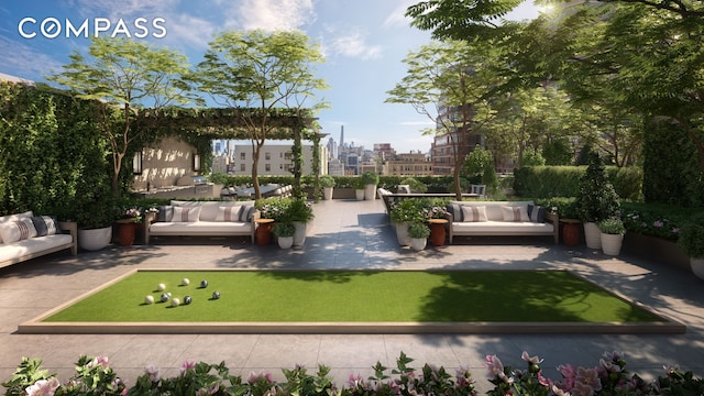 view of yard featuring outdoor lounge area, a bocce ball area, and a patio area