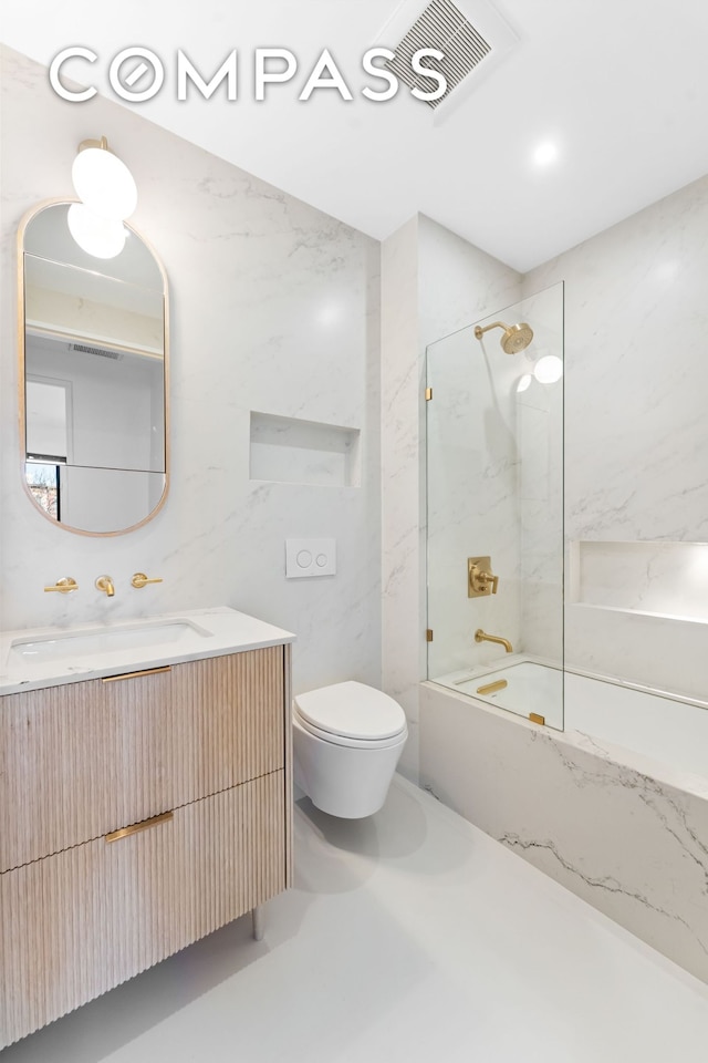 bathroom with toilet, vanity, and washtub / shower combination