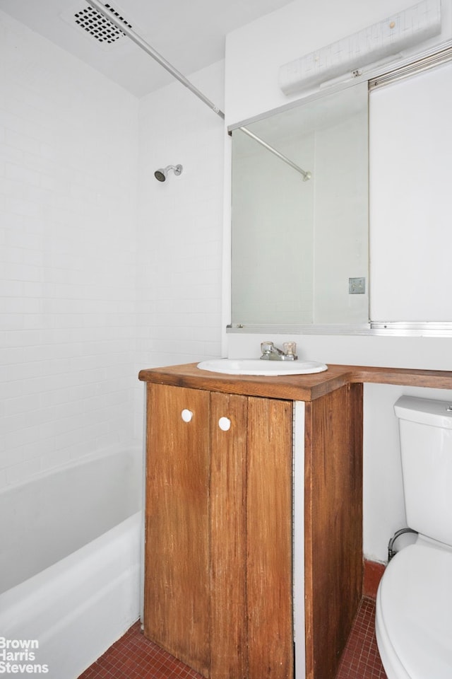 bathroom with toilet,  shower combination, tile patterned flooring, and vanity