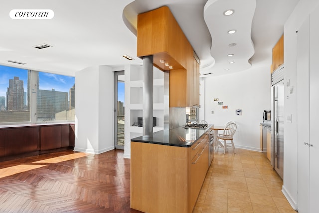 kitchen featuring baseboards, recessed lighting, stainless steel gas stovetop, and a view of skyline