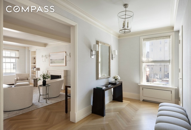40 E 66th St Unit 9A, New York City, NY 10065 - entrance foyer featuring crown molding, baseboards, a fireplace, and a chandelier