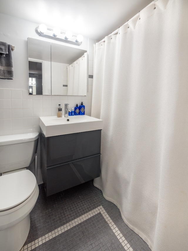 210 E 63rd St Unit 11B, New York City, NY 10065 - full bath featuring tile walls, tile patterned flooring, vanity, and toilet