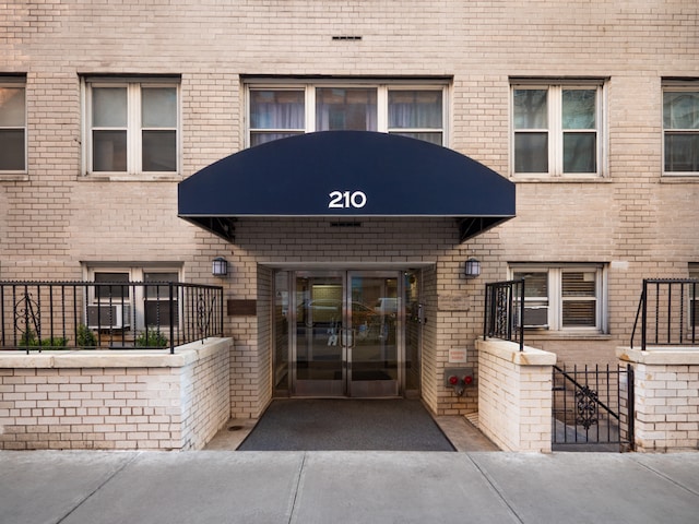 view of exterior entry with brick siding