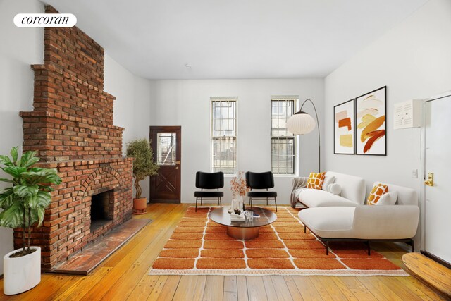 234 E 35th St Unit 5, New York City, NY 10016 - living room featuring hardwood / wood-style floors and a brick fireplace