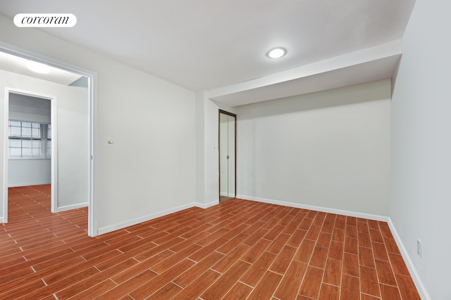 basement with baseboards and dark wood-type flooring