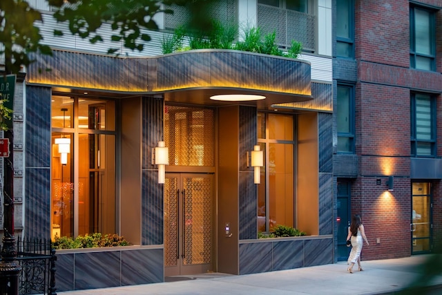 property entrance featuring brick siding