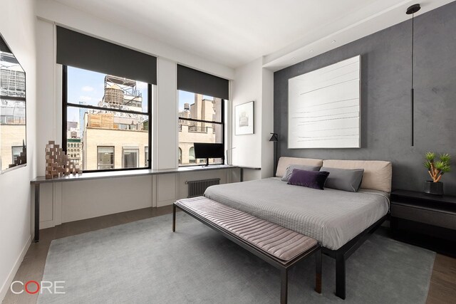 30 E 10th St Unit 10N, New York City, NY 10003 - bedroom featuring baseboards and wood finished floors