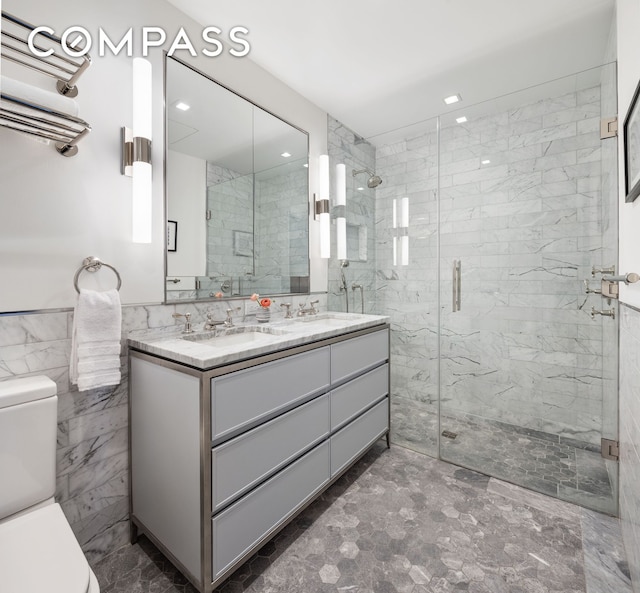 full bathroom with toilet, a stall shower, double vanity, recessed lighting, and tile walls
