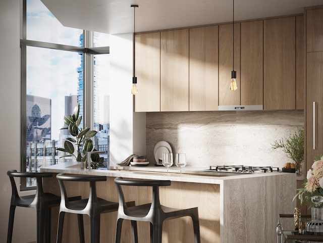 219 Hudson St Unit 5-A, New York City, NY 10013 - kitchen featuring backsplash, light countertops, stainless steel gas stovetop, a breakfast bar area, and floor to ceiling windows