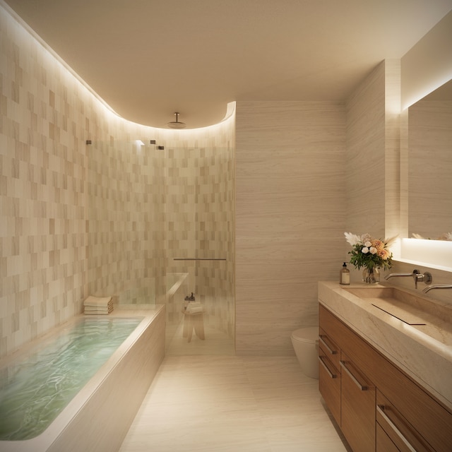 219 Hudson St Unit 5-A, New York City, NY 10013 - bathroom with toilet, tile walls, vanity, a bath, and tiled shower