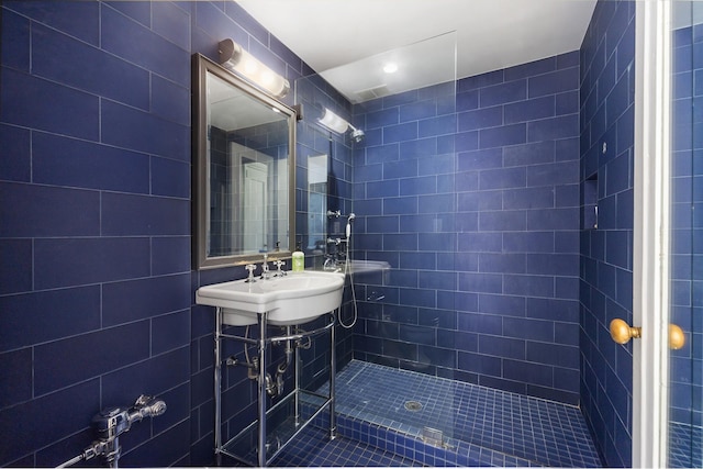 bathroom with a sink and tile walls
