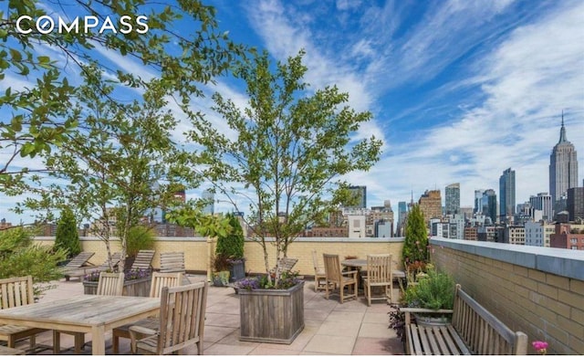 view of patio featuring outdoor dining space and a skyline view