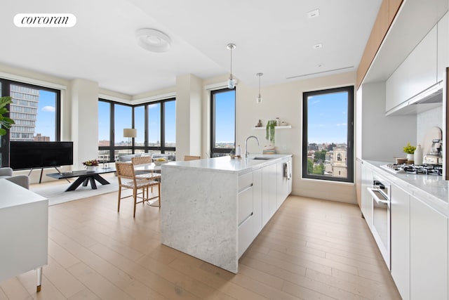 550 Vanderbilt Ave Unit 1101, New York City, NY 11238 - kitchen with white cabinets, modern cabinets, gas stovetop, and plenty of natural light