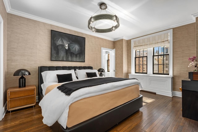 bedroom with crown molding, wallpapered walls, hardwood / wood-style flooring, and baseboards