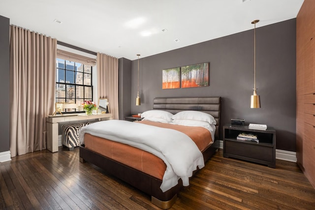bedroom with hardwood / wood-style floors and baseboards