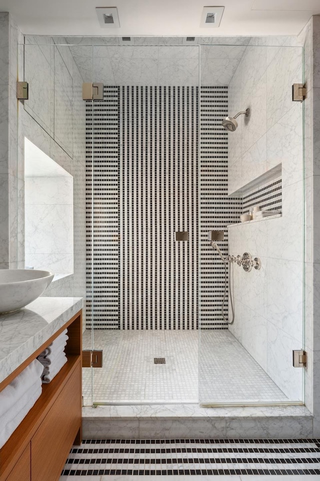 bathroom with a stall shower and vanity