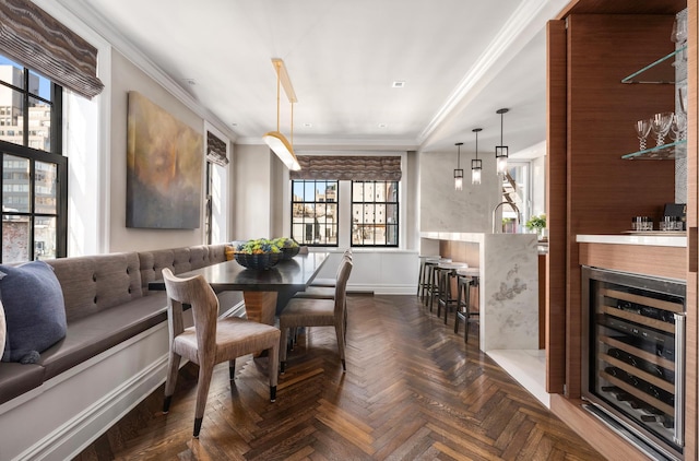 21 E 66th St Unit 8W, New York City, NY 10065 - dining room with beverage cooler, ornamental molding, baseboards, and a dry bar
