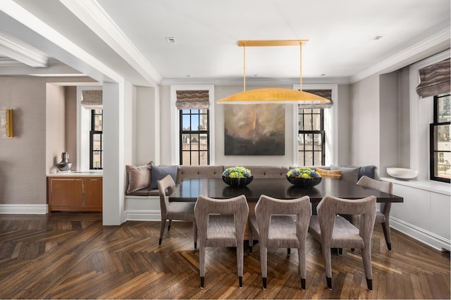 dining space with ornamental molding and baseboards