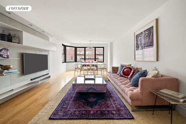 living area featuring wood finished floors and a chandelier