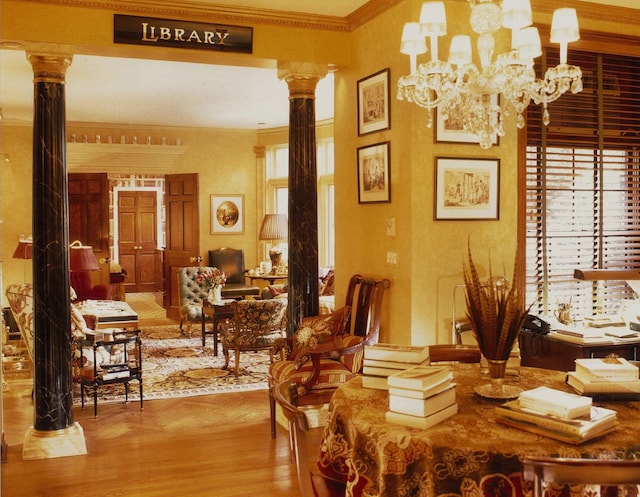 dining room with plenty of natural light, ornamental molding, and ornate columns