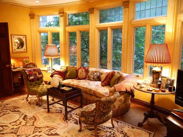 sunroom / solarium featuring ornamental molding and plenty of natural light