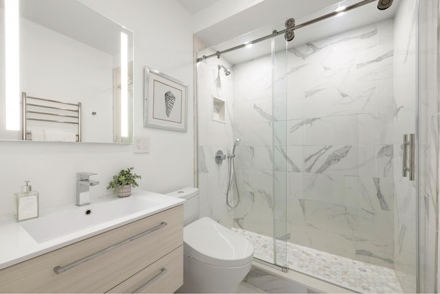 full bath with radiator, toilet, a marble finish shower, vanity, and a towel warming rack