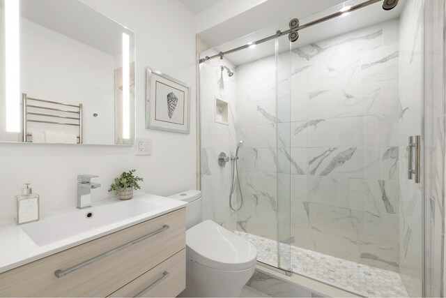 235 E 40th St Unit 6B, New York City, NY 10016 - full bathroom with radiator heating unit, toilet, a marble finish shower, vanity, and a towel warmer