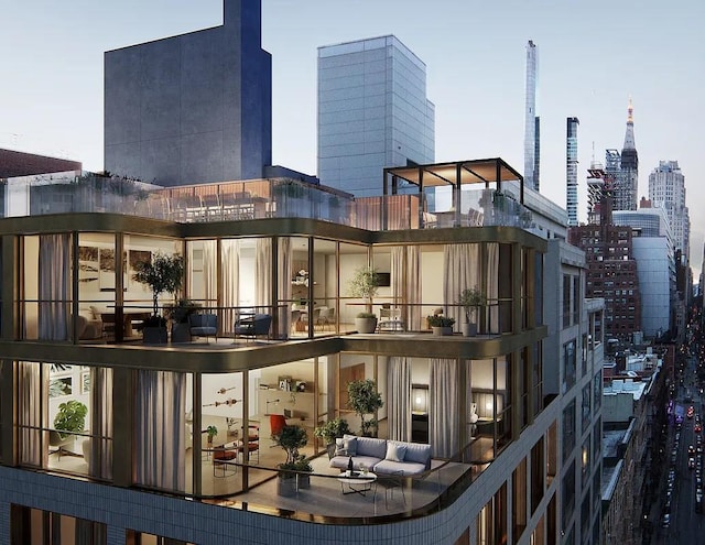 rear view of property with a view of city and a balcony