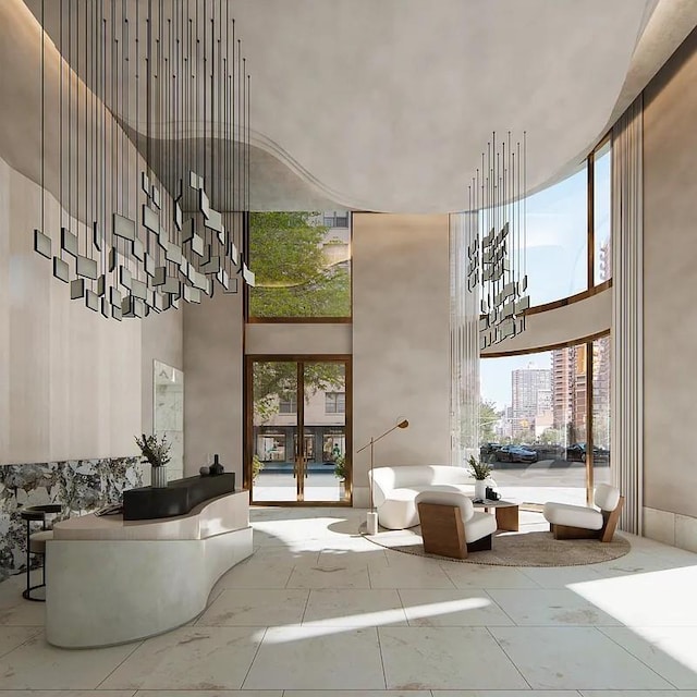 building lobby featuring a towering ceiling and a view of city