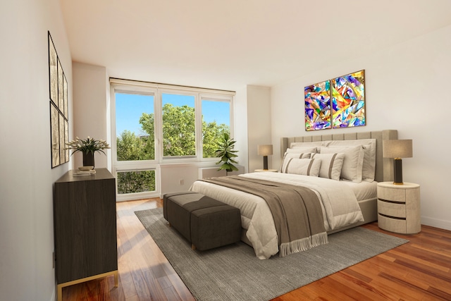 bedroom featuring baseboards and wood finished floors