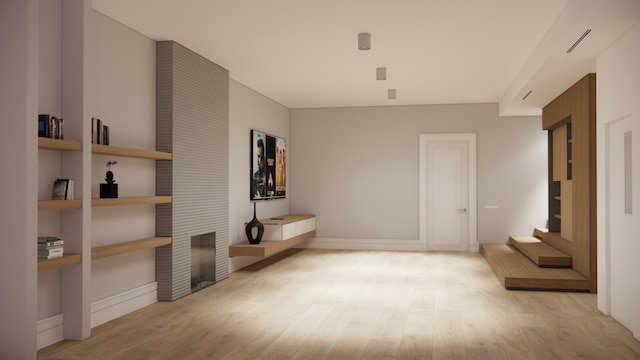 436 W 20th St Unit Th, New York City, NY 10011 - unfurnished living room with light wood finished floors, a fireplace, and baseboards