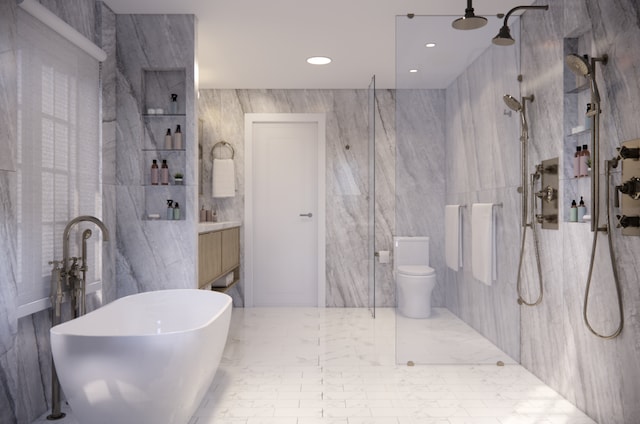 436 W 20th St Unit Th, New York City, NY 10011 - bathroom featuring tile walls, a marble finish shower, toilet, a freestanding tub, and recessed lighting