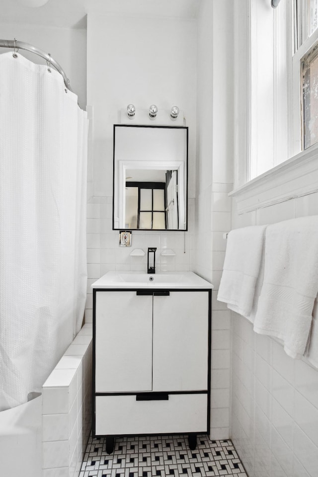 bathroom featuring tile walls and vanity