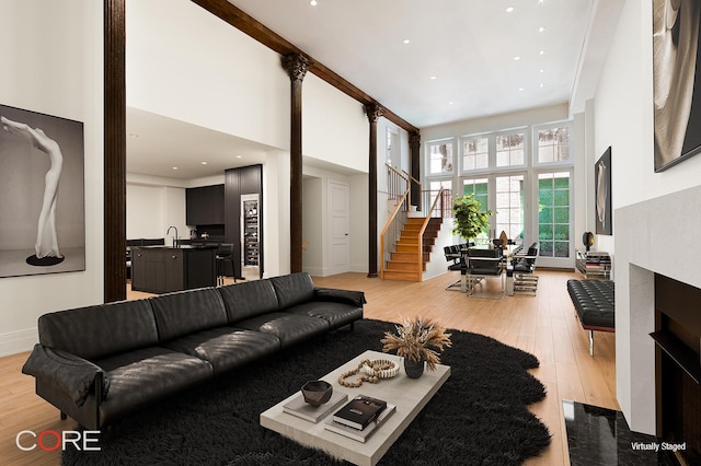 87 Leonard St Unit Mais1B, New York City, NY 10013 - living area with light wood-style floors, a fireplace with flush hearth, a high ceiling, and stairway