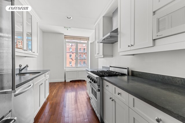 400 E 51st St Unit 4E, New York City, NY 10022 - kitchen featuring appliances with stainless steel finishes, a sink, dark wood-style floors, white cabinetry, and recessed lighting